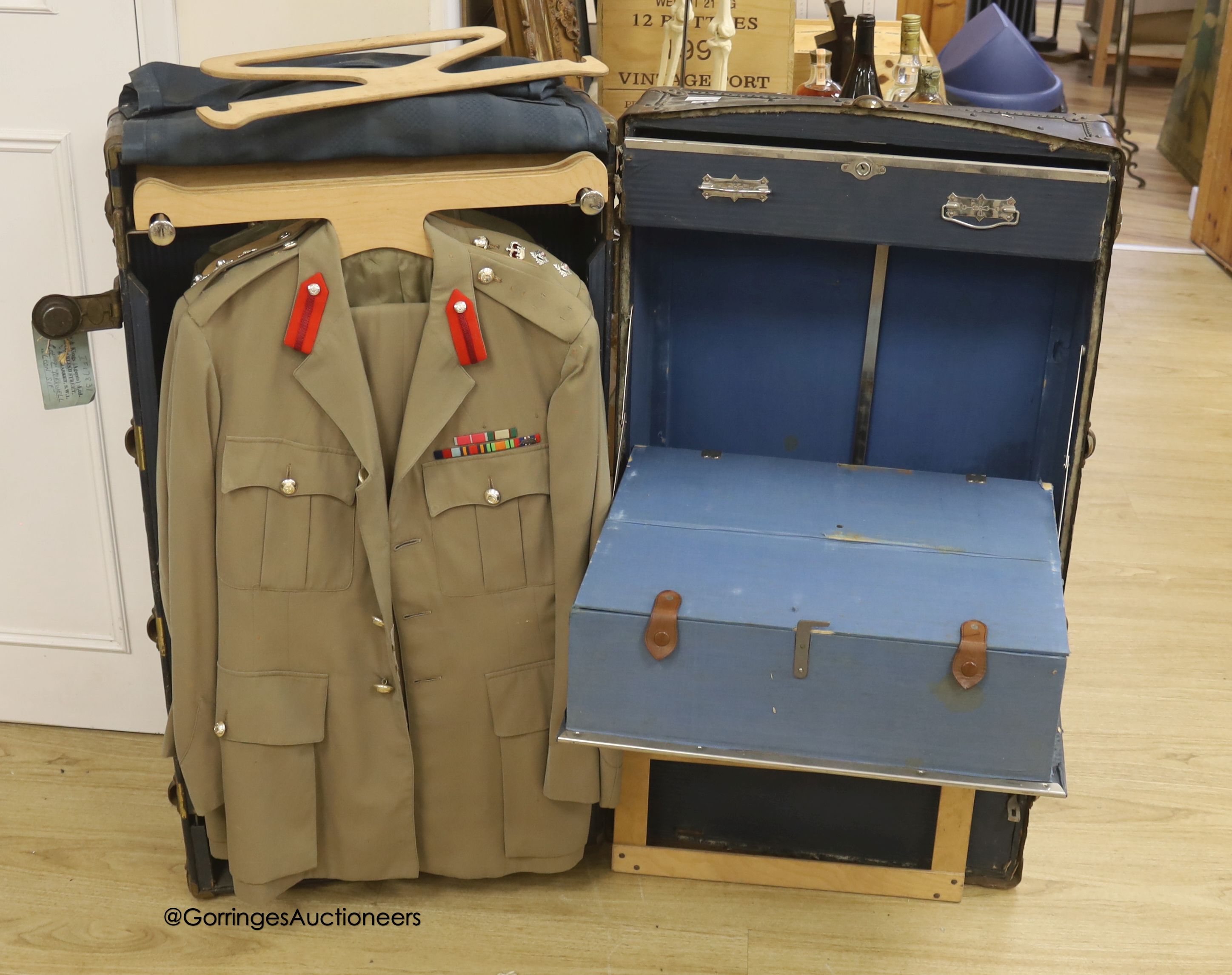 Three Khaki uniforms, one jacket without trousers, contained within a cabin trunk